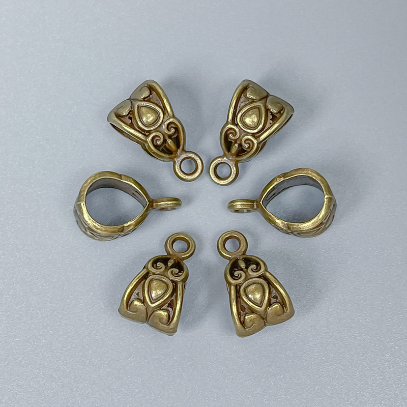 Bronze-colored bail finding, dimensions 13 x 7 x 8 mm ±, hole diameters 6 mm ± and 1.8 mm ±, packaging 24 pcs