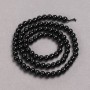 Beads on a cord of natural stone — Black Tourmaline, smooth round beads, diameter 4–5 mm, length 39 cm