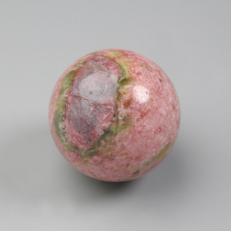 Rhodonite natural stone souvenir sphere, diameter 50-60 mm ± assorted sizes, weight from 200 g (price per 100 g)