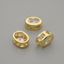 Bead insert with white crystal, gold-tone metal, oval, 9x7 mm ± hole 1.3 mm, per piece