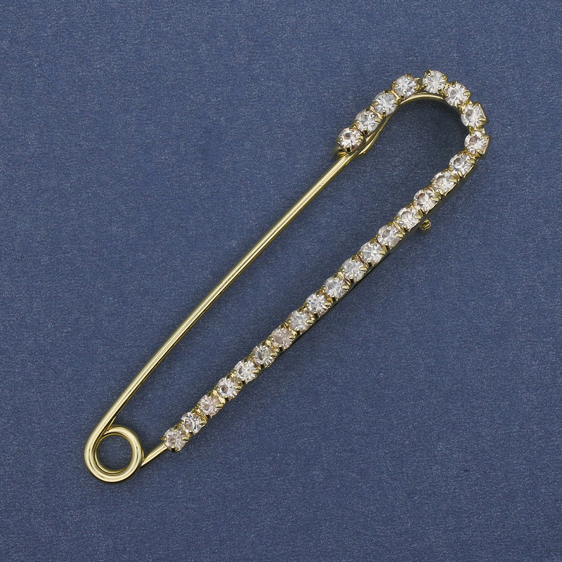 Brooch pin with white rhinestones 72x16 mm ± gold-toned metal