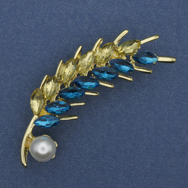 Brooch 'Kolosok' with yellow and blue crystals, pearl, gold-tone metal 55×15 mm +