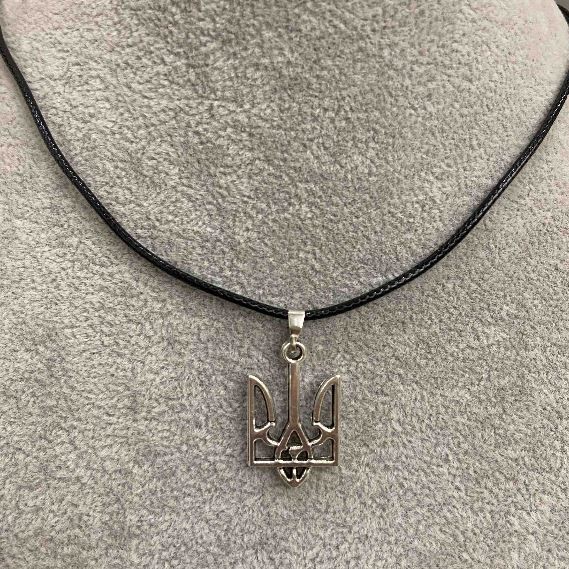 Trident pendant 25x15mm± silver-toned metal on an eco-leather cord, length 60 cm +5 cm chain
