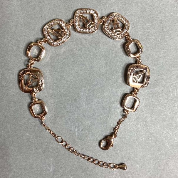 Gold-tone metal bracelet with white rhinestones, 12 mm diameter, 16 mm length, and a 3 cm extender chain