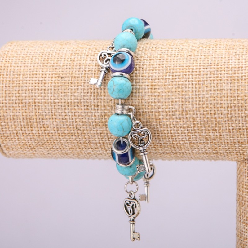 Bracelet-amulet Turquoise (single ) with blue 'little eyes' on an elastic cord, diameter 10 (+- ) mm, length 18 cm with inserts and pendants