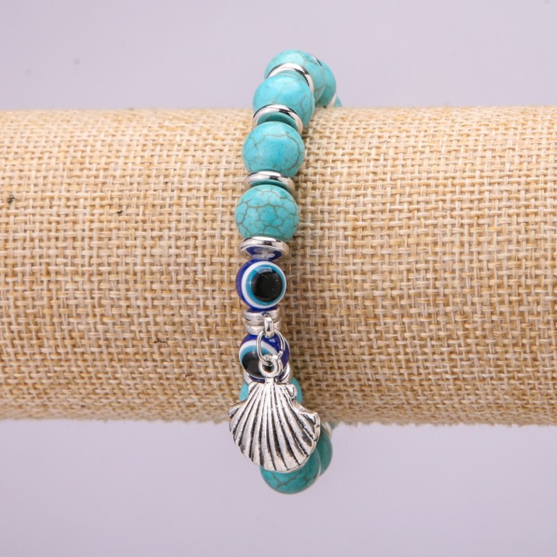 Turquoise Charm Bracelet (single ) with blue “Evil Eye” beads on elastic cord, diameter 10 (±) mm, length 18 cm with inserts and a pendant