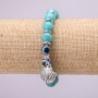 Turquoise Charm Bracelet (single ) with blue “Evil Eye” beads on elastic cord, diameter 10 (±) mm, length 18 cm with inserts and a pendant