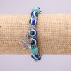 Turquoise bracelet on elastic cord (single) with blue "evil eyes", bead diameter 10 (±) mm, length 18 cm with inserts and a pendant Sea Star