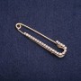 Brooch pin with white rhinestones 57×13 mm, gold-tone metal