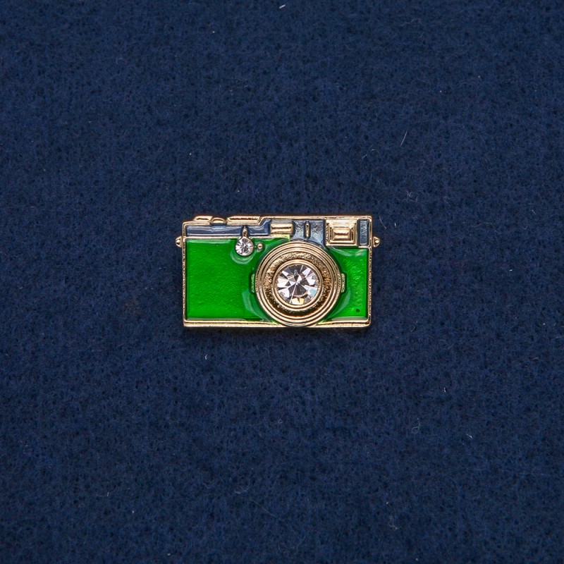 Brooch 'Camera' in gold-toned metal with green enamel and white stones 30×17 mm +