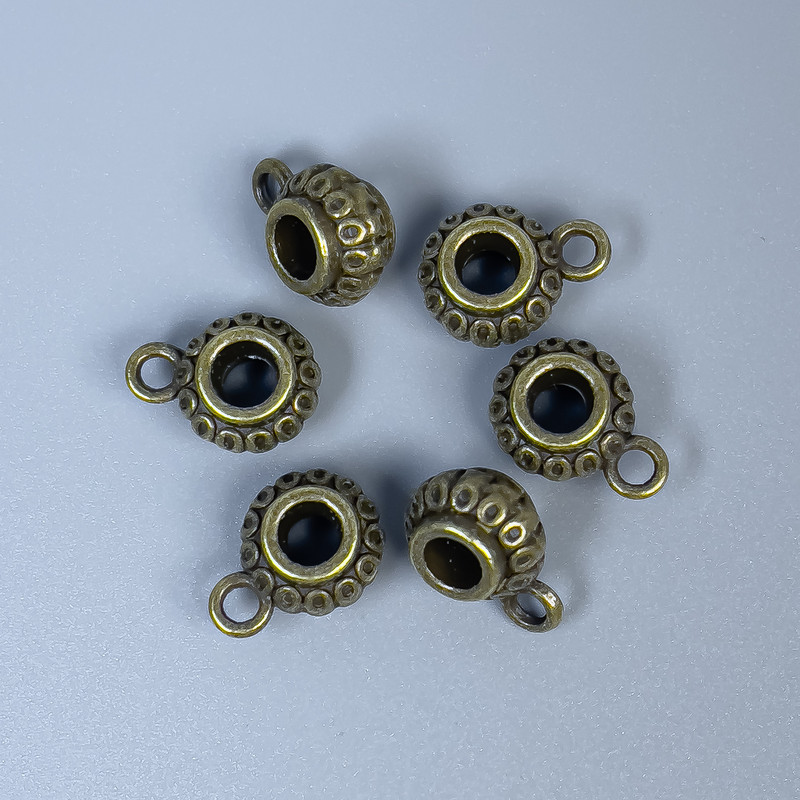 Bronze-colored bail findings, bronze metal color, dimensions 12×8×6 mm ±; hole diameters 4 mm ± and 2 mm ±; packaging 20 g (~18 pcs)