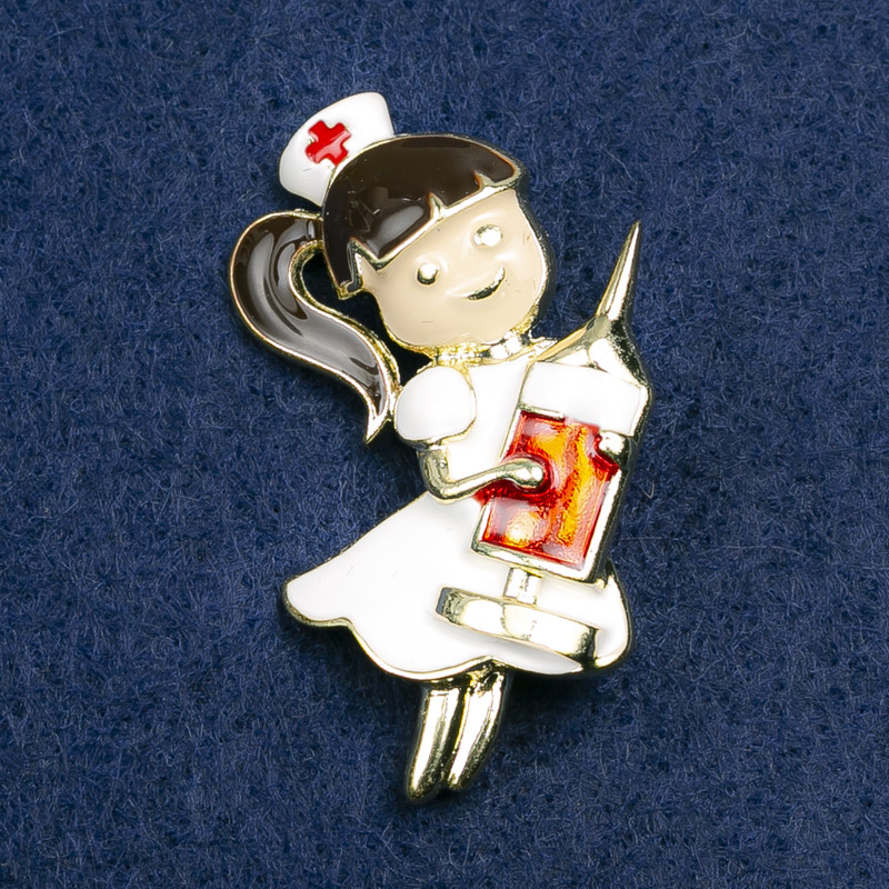 Brooch 'Nurse', white, black, and red enamel, golden metal 42x31 mm